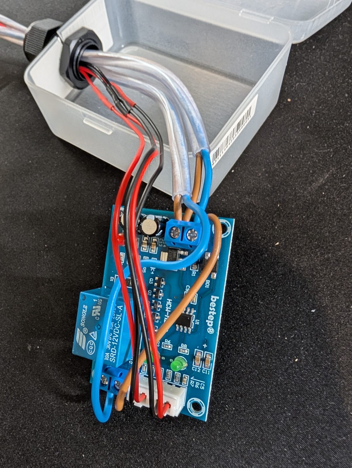 The controller board wired up in its clear box before closing
