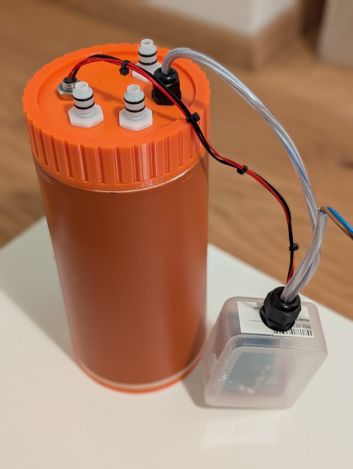 The finished sump standing on a table before installation, controller box beside it
