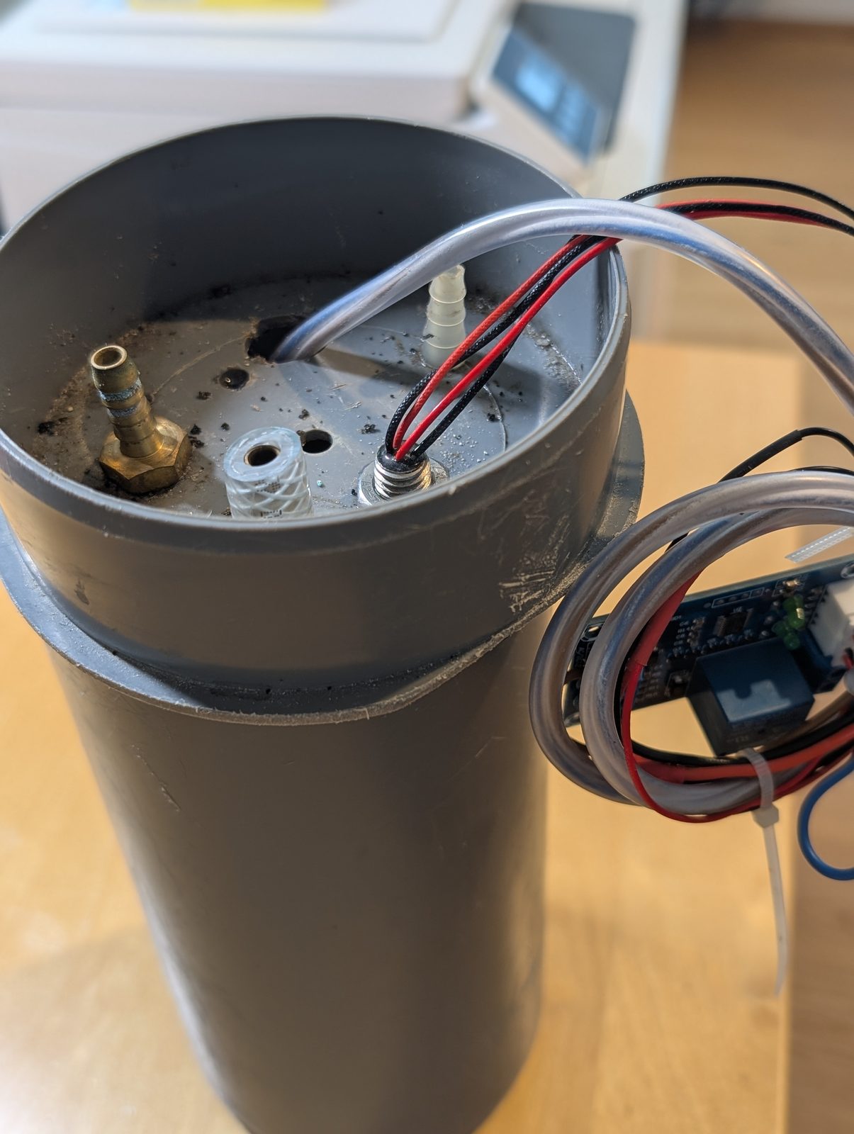 The prototype lid with brass hose barbs and cable glands